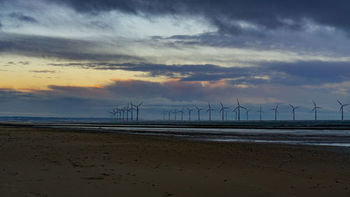 Scenic view of beach against sky during sunset