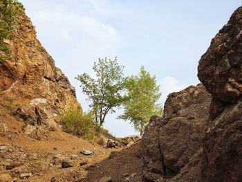 Low angle view of rock formations against sky