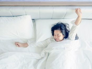 Young woman sleeping on bed at home