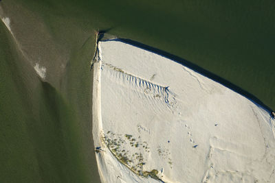 High angle view of umbrella on land against wall