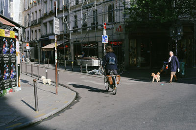 People riding bicycle on city street