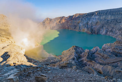 High angle view of smoke emitting from hot spring amidst mountains