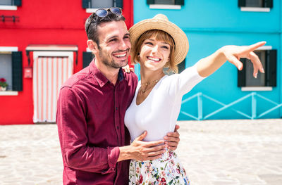 Happy friends smiling while standing outdoors