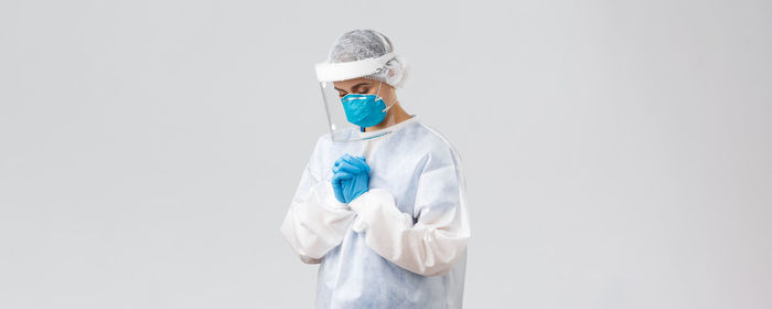 Rear view of woman wearing hat against white background