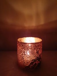 Close-up of illuminated lamp on table