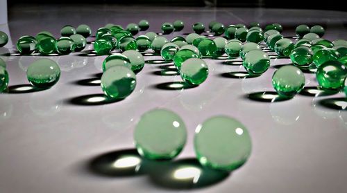 Close-up of green balls on tiled floor