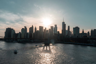 Sunset over east river and financial district manhattan, nyc. view of brooklyn bridge