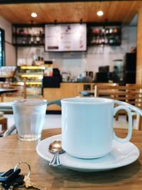 Close-up white coffee mug in cafe.