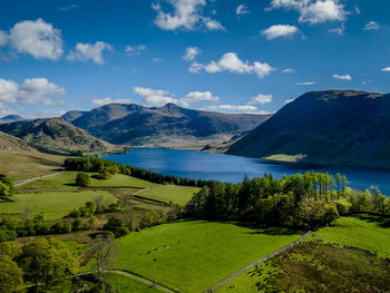 Scenic view of lake and mountains against sky