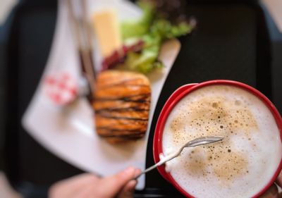 Close-up of hand holding coffee cup