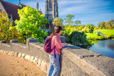 Rear view of woman standing against building