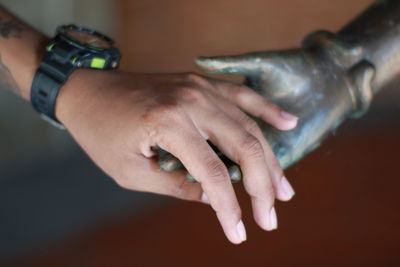 Close-up of man holding statue