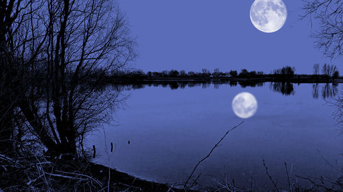 Low angle view of moon against blue sky