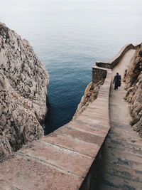 High angle view of people on sea shore against sky