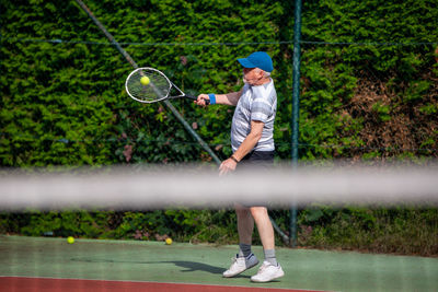 Full length of man playing tennis