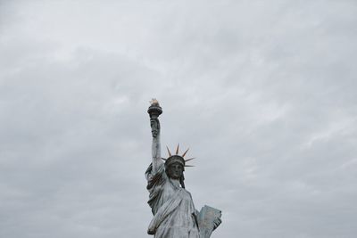 Low angle view of statue against cloudy sky