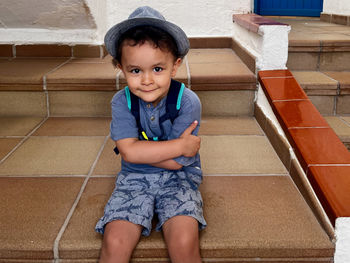 Low section of boy standing on staircase