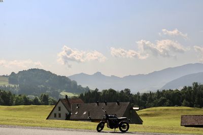 Motorcycle on field against sky