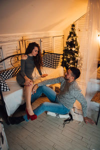 Young couple sitting on floor at home