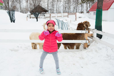 Full length portrait of girl in snow