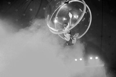 Low angle view of illuminated lighting equipment hanging from ceiling