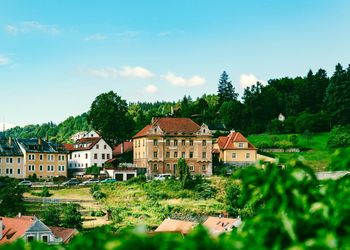 Houses in town against blue sky