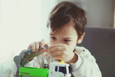 Boy playing with toys at home