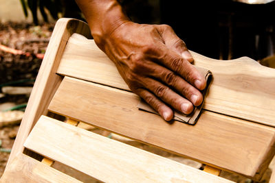 Close-up of hand working on wood