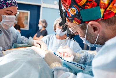 Female dentist examining patient at clinic