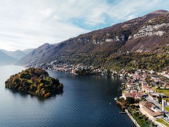 Scenic view of como lake townscape by mountains against sky