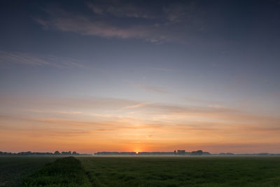 Scenic view of field against sky during sunset