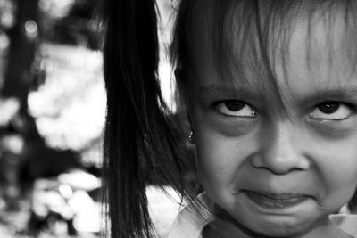 Close-up of girl making face outdoors