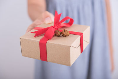 Close-up of hand holding paper in box