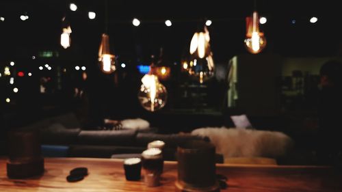Close-up of illuminated candles on table