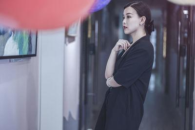 Side view of young woman looking away