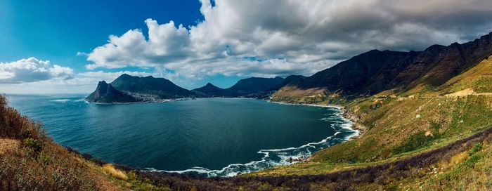 Panoramic view of sea and mountains against sky