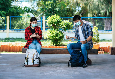 Full length of man sitting in park