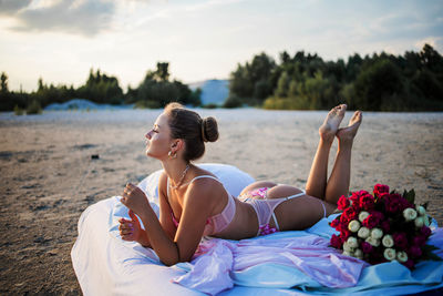 Portrait of young woman sitting on beach