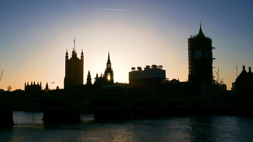 View of buildings in city at sunset