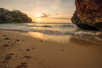 Scenic view of beach against sky during sunset