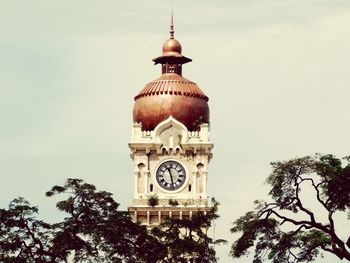 Low angle view of clock tower against sky
