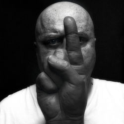 Portrait of man wearing hat against black background