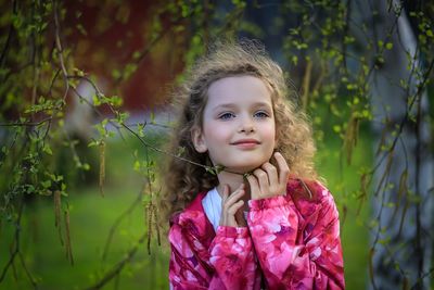 Portrait of smiling girl against plants