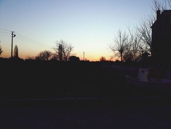 Silhouette trees against sky during sunset