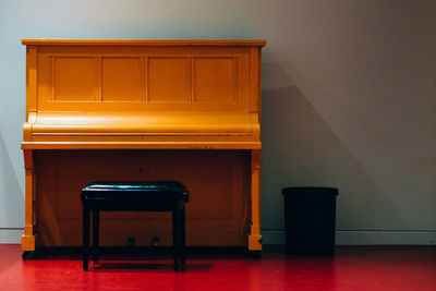 Empty stool in front of piano table at home