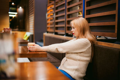 Woman having drink in restaurant