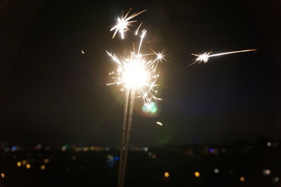 Low angle view of firework display at night