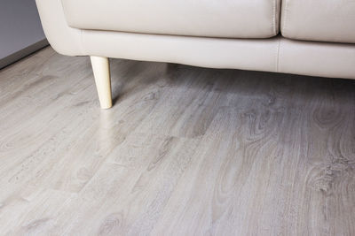 High angle view of empty chair on hardwood floor at home