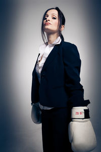 Young woman standing against white background