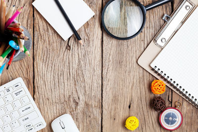 Directly above shot of office supplies on wooden table